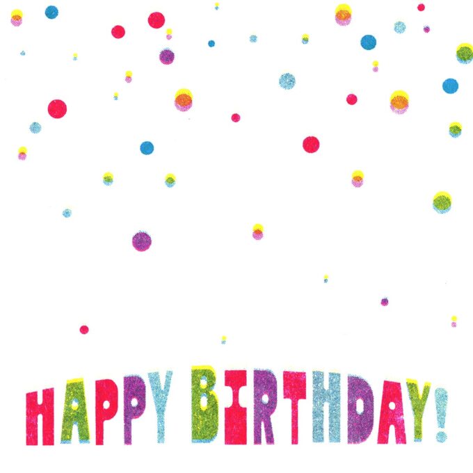 Close up view of a happy birthday card with multi-colored falling dots that look like confetti